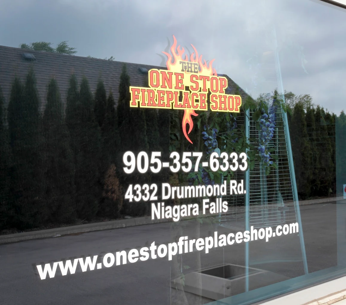 The One Stop Fireplace Shop storefront door at 4332 Drummond Road, Niagara Falls, showing the address and phone number